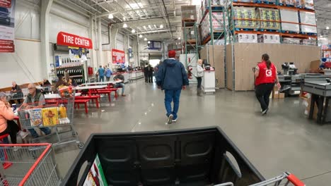 POV---At-Costco,-slowly-pushing-the-chart-from-the-Checkout-stand,-through-the-food-court-and-towards-the-exit