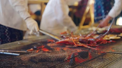 Japanese-Spiny-Lobsters-Being-Grilled-by-Ama-Divers-in-Osatsu-Seaside-Hut,-Toba