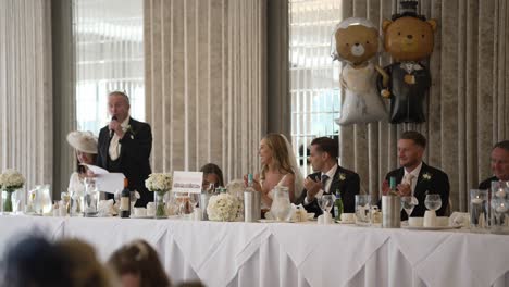 Father-of-the-bride-welcomes-guests-and-party-to-the-wedding-dinner