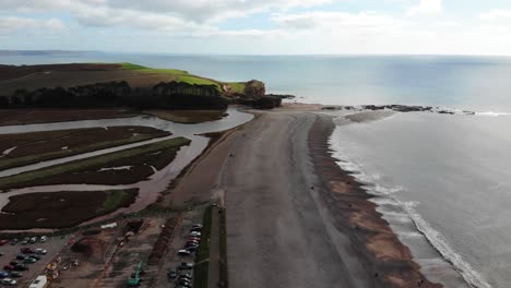Aerial-panning-right-shot-of-Budleigh-Salterton-Beach-Devon-England-on-a-calm-day