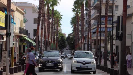 Elderly-people-with-face-masks-cross-road-in-Antibes,-France-in-2020