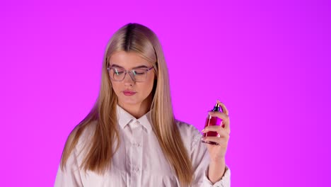 Close-up-woman-testing-new-perfume-on-wrist-and-smells-it,-happy-smile-at-camera