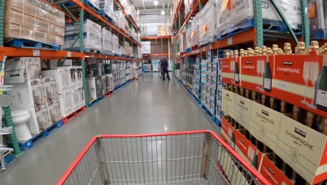 POV---At-Costco,-slowly-pushing-a-chart-an-aisle-containing-products-for-home-improvement