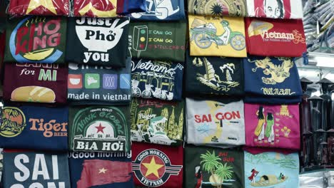 Assorted-colorful-T-shirts-on-display-with-Vietnamese-symbols-and-slogans