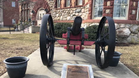 4-K-editorial-footage-of-a-cannon-in-front-of-a-building-in-a-small-town