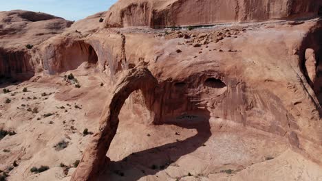 A-high-flying-drone-shot-of-the-Corona-Arch,-a-massive-natural-sandstone-arch-located-in-a-side-canyon-of-the-Colorado-River,-just-west-of-Moab,-Utah