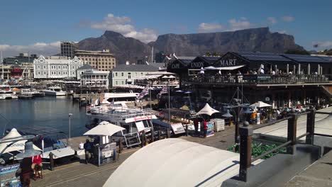 Slow-pan-of-Cape-Town-waterfront-and-Table-Mountain,-ending-on-ferris-wheel