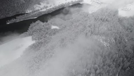 flying-above-clouds,-snowy-forest-and-lake,-Austria,-drone,-aerial