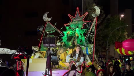 Wizard-king-on-a-moving-float-greeting-people-and-children-while-throwing-candy-at-Christmas-in-Barcelona