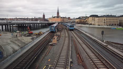 Overhead-view-of-subway-trains-moving-in-both-directions-on-bridge-in-Stockholm