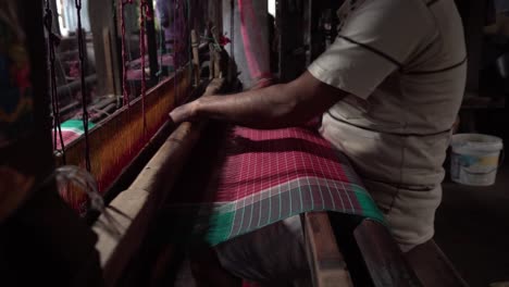 A-weaver-weaves-cloth-in-an-ancient-way