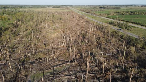 Tornado-damage-in-forest-landscape-near-I96-highway-in-USA,-aerial-view