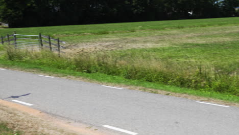 Expensive-sport-car-Mercedes-AMG-driving-on-the-road-by-the-water-in-the-countryside