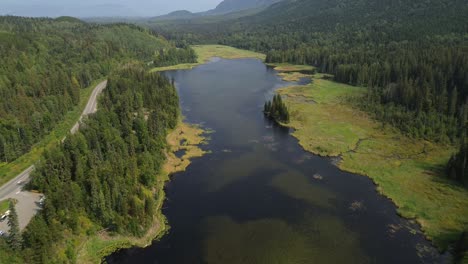 Pull-Out-Dolly-Drone-Shot-Across-Seeley-Lake-Provincial-Park-with-Alpine-Forest-Trees-in-Smithers,-Canada