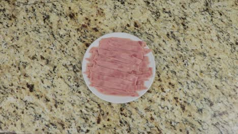 Serving-ham-slices-on-a-plate,-top-down-view