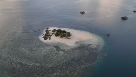 Aerial-view-at-sunrise-of-tiny-Gili-Kedis-island-off-the-coast-of-Lombok,-Indonesia