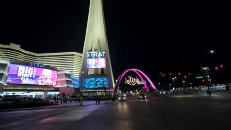 Tilt-up-Reveal-Of-The-Strat-Hotel,-Casino,-And-Tower-At-Night-In-Las-Vegas-Strip,-Nevada