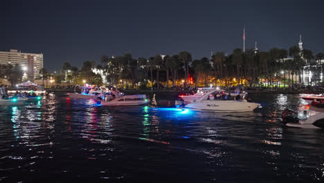 Illuminated-Boats-Cruising-On-Hillsborough-River-At-Night-During-Holiday-Boat-Parade-In-Tampa,-Florida