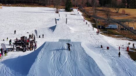 Snowboarder-perform-double-backflip-on-Dolni-Morava-skiing-track-ramp