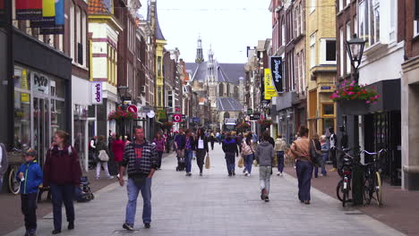 Pedestrians-walking-in-the-city-center-of-Alkmaar,-shopping-street,-Netherlands