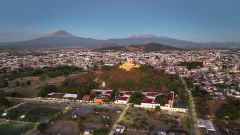 Drone-shot-approaching-the-church-on-the-Cholula-Pyramid,-in-sunny-Puebla,-Mexico