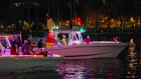 People-In-Illuminated-Boats-At-Holiday-Boat-Parade-At-Night-In-Tampa,-Florida