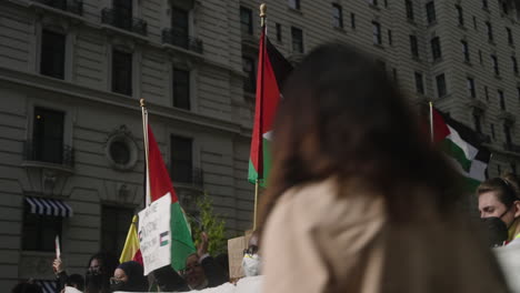 A-Palestinian-Flag-Held-in-the-Air-in-a-Group-of-Pro-Palestine-Protestors