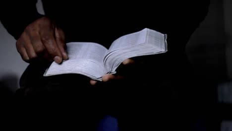man-praying-with-bible-with-black-background-with-people-stock-video-stock-footage