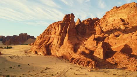 Rock-mountain-formation-in-desert-in-Al-Ula,-Saudi-Arabia---Aerial-drone-view-at-sunset
