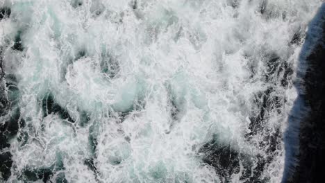 Turquoise-waves-crashing-against-rocky-shores-at-Shete-Boka-National-Park,-Curacao,-aerial-view