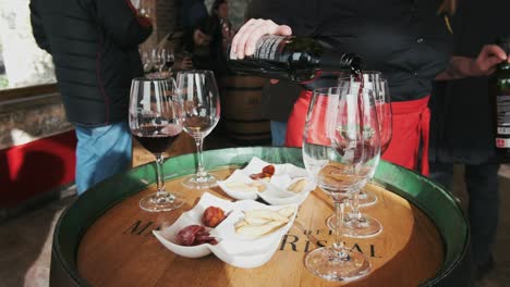 Red-wine-pouring-into-glass-at-tasting-event-with-some-tapas-and-chorizo