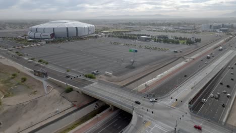 State-Farm-Stadium,-home-of-the-Arizona-Cardinals-National-Football-League-team-in-Glendale,-Arizona-with-freeway-drone-video-wide-shot-stable