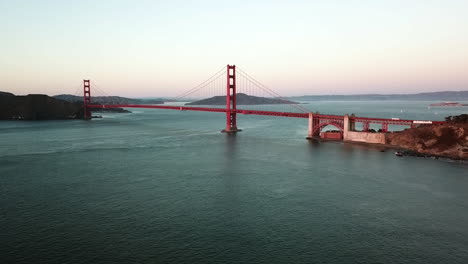 Aerial-rising-shot-toward-the-Golden-gate-bridge,-sunrise-in-San-Francisco,-USA