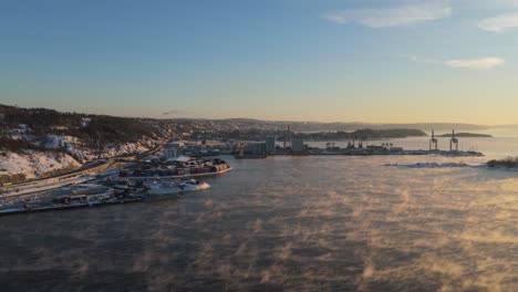 Golden-Hour-Sunset-Light-Over-Port-Near-Bjorvika,-Oslo-With-Fog-Floating-Above-Water