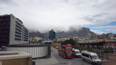 Sightseeing-bus-and-other-vehicles-stand-still-on-a-road-in-central-Cape-Town,-South-Africa