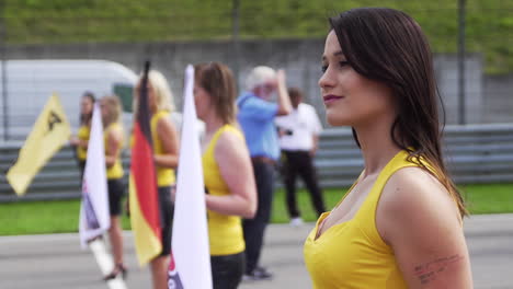 Cute-paddock-girl-turning-head-and-flicking-hair,-grid-girl,-promotional-girl