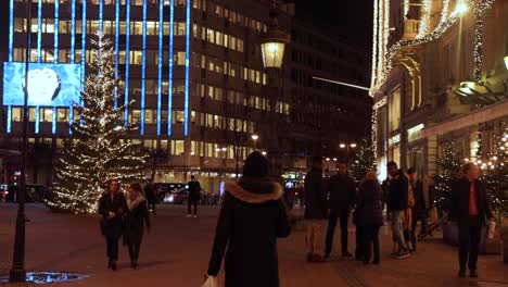 People-walk-around-at-Chrismas-lit-city-square-Stureplan-in-Stockholm