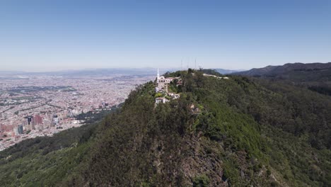 Panoramic-drone-shot-around-the-Monserrate-Sanctuary,-in-sunny-Bogota,-Colombia