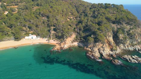 Aerial-exploration-captures-the-essence-of-Lloret-De-Mar's-charm-and-the-hidden-treasure-of-Cala-Canyelles,-nestled-within-Costa-Brava's-coastline