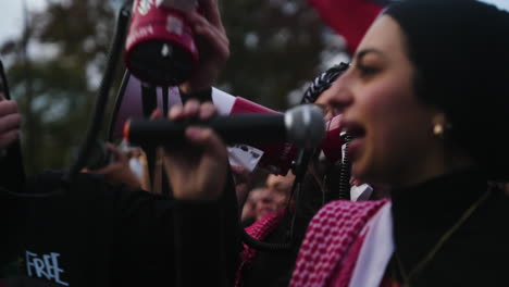 A-Close-Up-Shot-of-an-Arab-Woman-with-a-Microphone-Leading-a-Chant-at-a-Pro-Palestine-Protest
