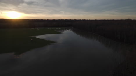 Sunset-over-Loosahatchie-River-with-reflective-water,-serene-landscape,-aerial-view