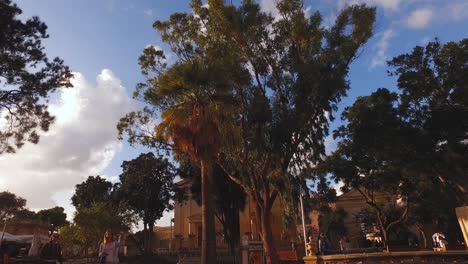 Walking-through-the-arches-in-the-beautiful-Upper-Barrakka-Gardens-located-in-Valletta,-Malta-on-a-bright-sunny-day