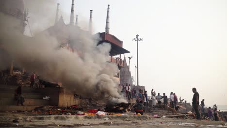 Profile-view-of-smoke-in-burning-ghat-during-evening-in-Varanasi,-India