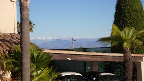 Snow-capped-Maritime-Alps-mountains-seen-from-Cannes-France-in-sunny-day,-Handheld-medium-shot