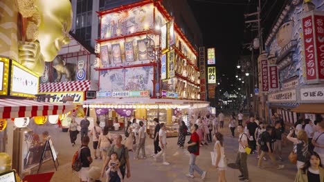 High-moving-slow-motion-shot-of-Ebisu-Higashi-District's-Bustling-Streets,-Crowded-with-Vibrant-City-Lights-and-Energetic-Nightlife-Osaka,-Japan