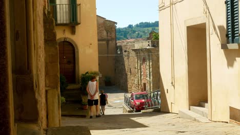 A-few-people-mosey-down-the-street-in-Monte-San-Savino,-a-beautiful-little-Tuscan-town,-home-of-the-Sagra-della-Porchetta-food-festival