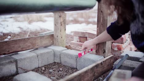 The-Man-is-Using-a-Level-to-Ensure-the-Surface-of-the-DIY-Hot-Tub-is-Aligned---Close-Up