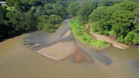 River-And-Lush-Vegetation-In-Currumbin-Valley,-Gold-Coast,-QLD,-Australia---Drone-Shot