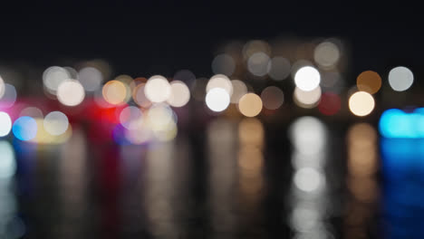 Colorful-Bokeh-of-Holiday-Lights-During-Christmas-Boat-Parade-On-River-At-Night