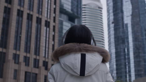 Young-girl-admiring-tall-buildings-in-Guangzhou-City